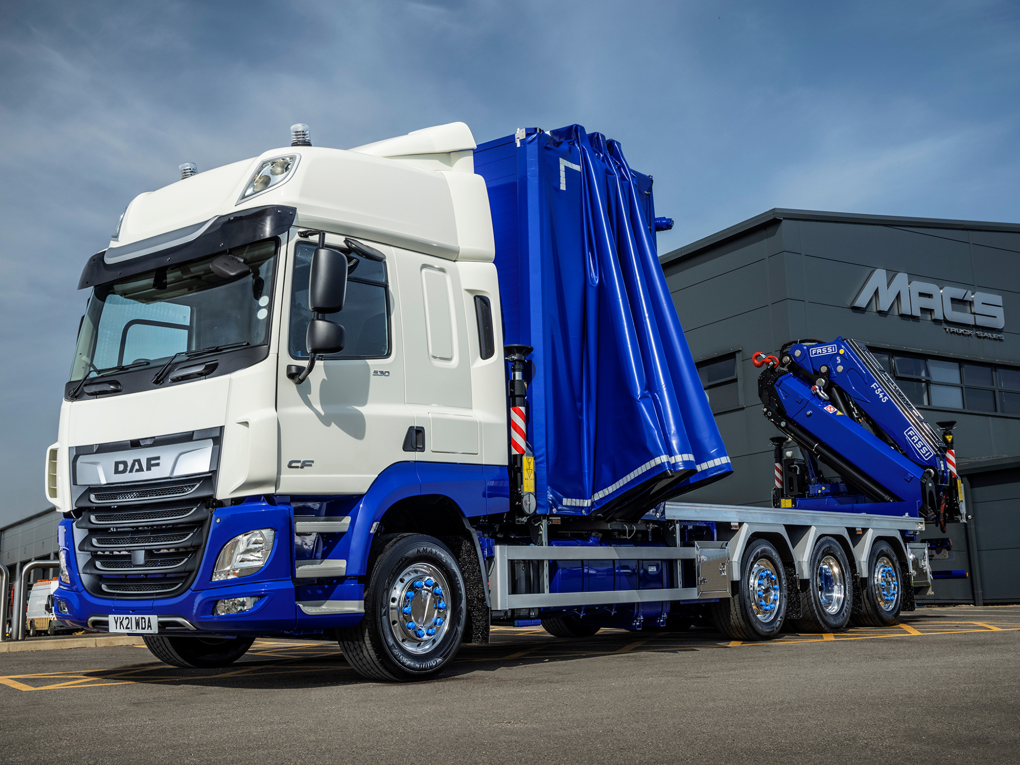 A curtainsider truck with a crane ready to rent and hire